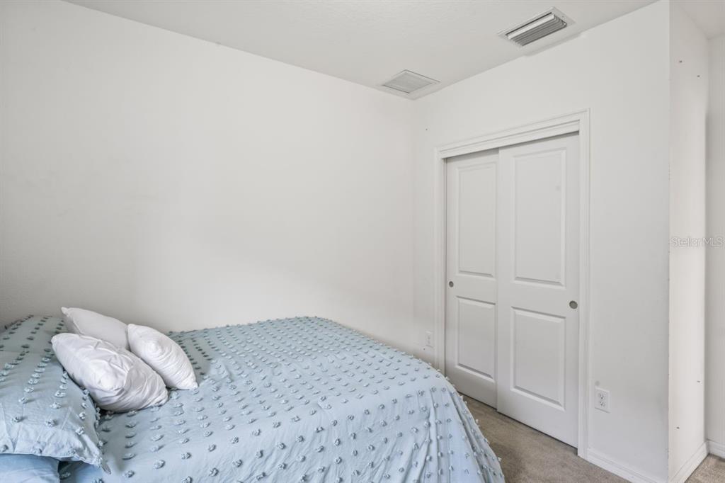 571 Old Windsor Way Spring Hill, FL 34609 - Photo 31 of 61 a bedroom with a bed