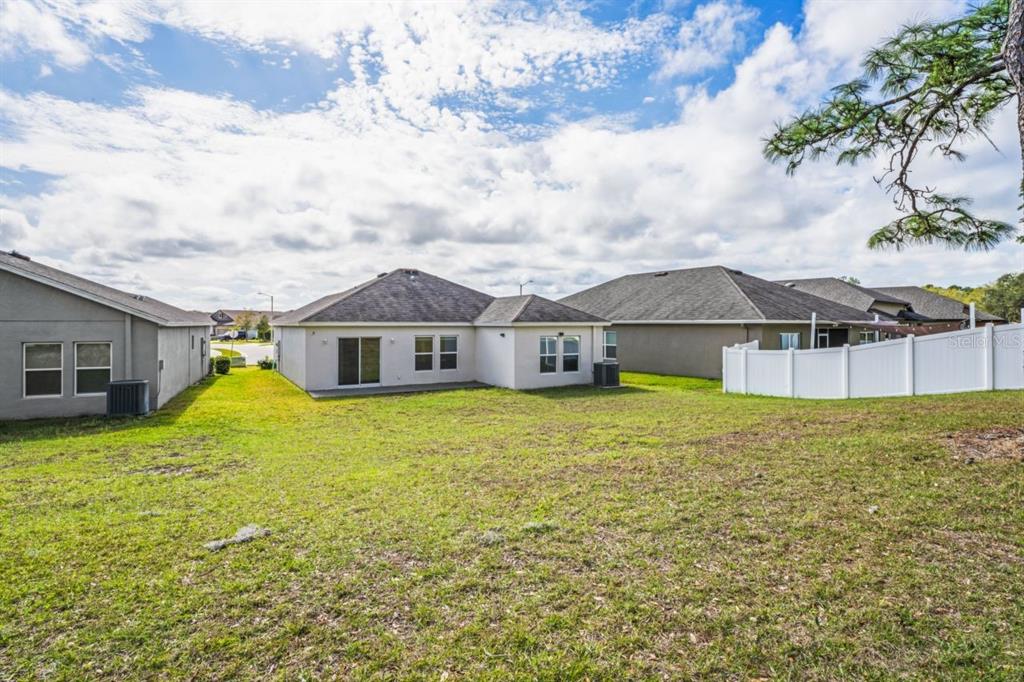 571 Old Windsor Way Spring Hill, FL 34609 - Photo 36 of 61 a front view of house with yard and seating area