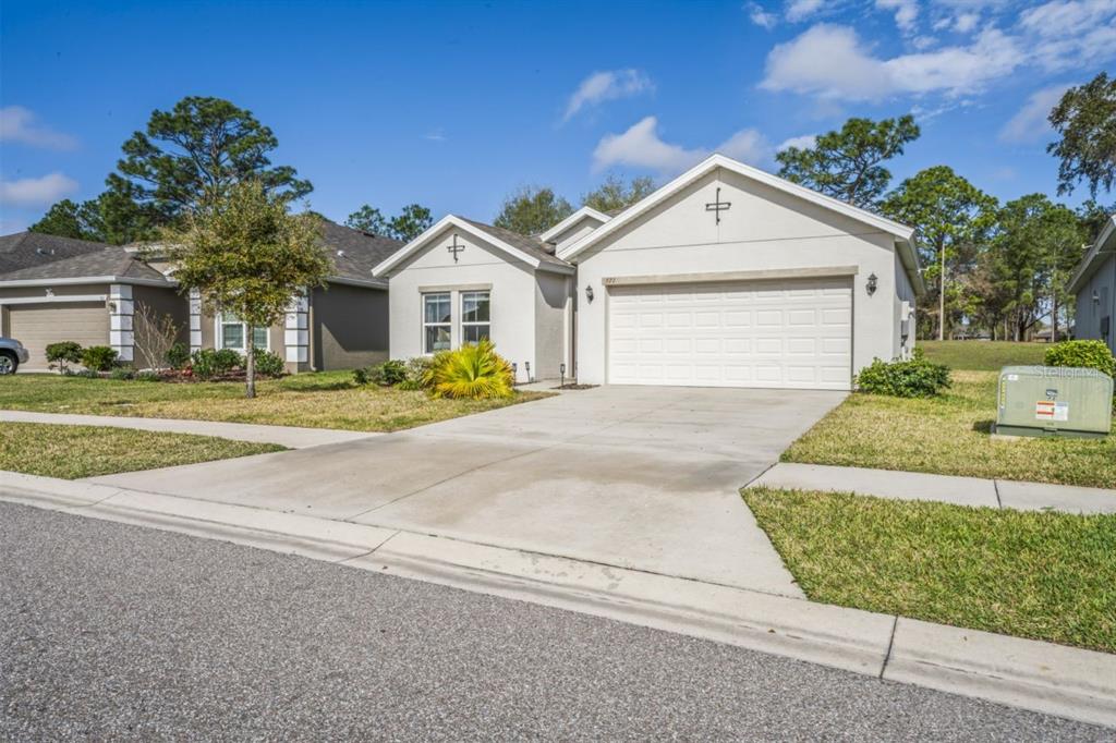 571 Old Windsor Way Spring Hill, FL 34609 - Photo 46 of 61 a front view of a house with a yard and garage