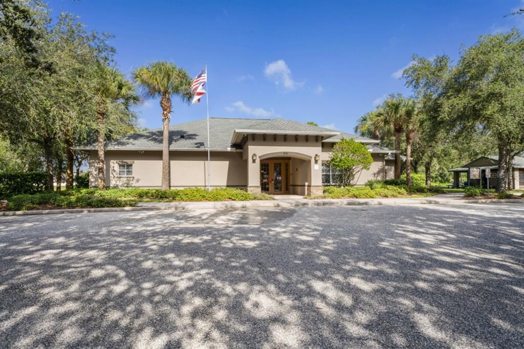 571 Old Windsor Way Spring Hill, FL 34609 - Photo 52 of 61 a view of a house with a yard and a garage
