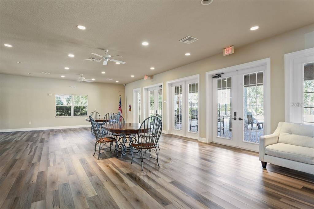 571 Old Windsor Way Spring Hill, FL 34609 - Photo 57 of 61 a view of a dining room with furniture window and wooden floor