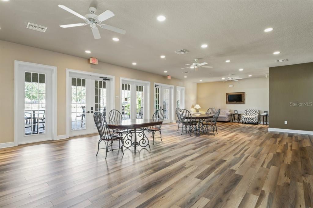 571 Old Windsor Way Spring Hill, FL 34609 - Photo 58 of 61 a view of a dining room with furniture and wooden floor