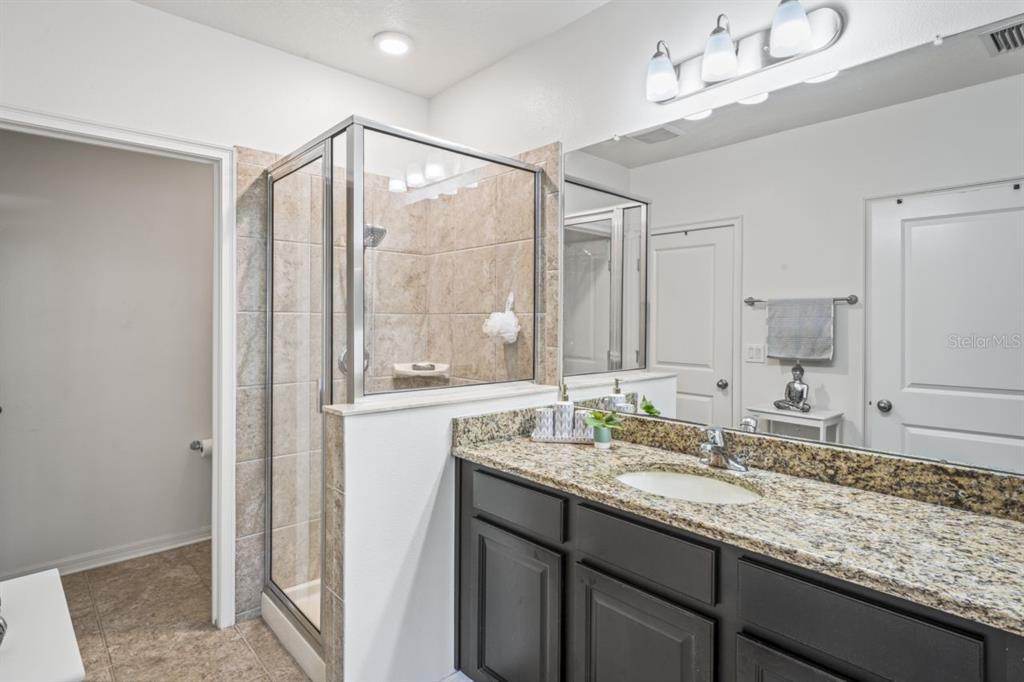 571 Old Windsor Way Spring Hill, FL 34609 - Photo 8 of 61 a bathroom with a granite countertop sink mirror and double