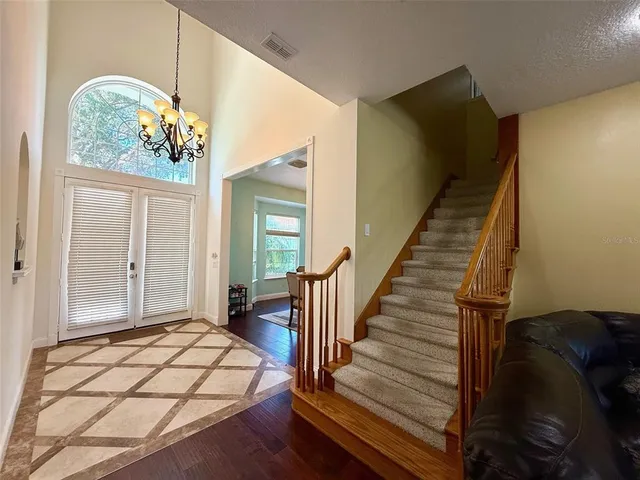 a view of a livingroom with wooden floor and stairs