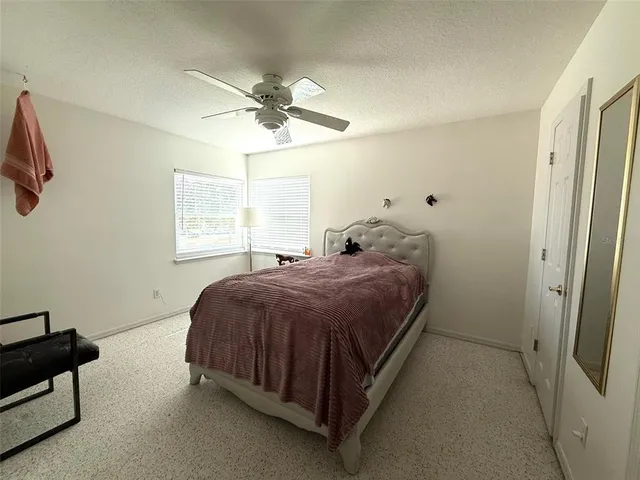 a spacious bedroom with a bed and a window
