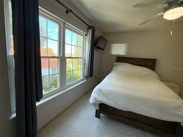 a bed sitting in a bedroom next to a window