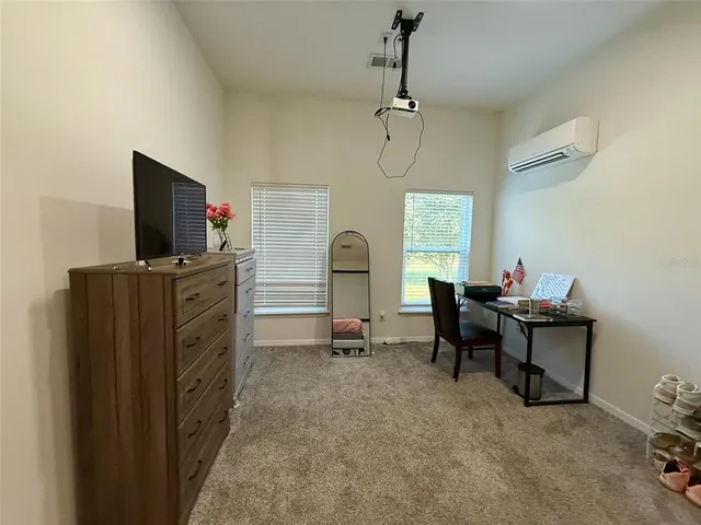 a view of a workspace with furniture and a window