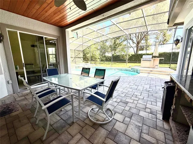 a view of a patio with a dining table and chairs