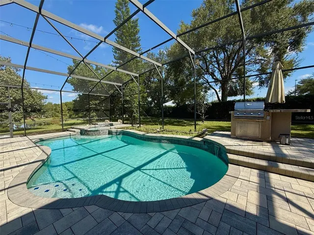 a view of a swimming pool with a patio