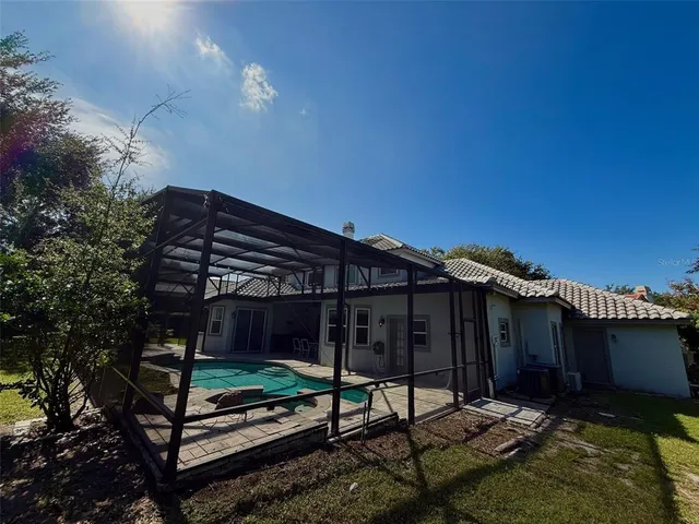 a view of house with backyard and outdoor seating