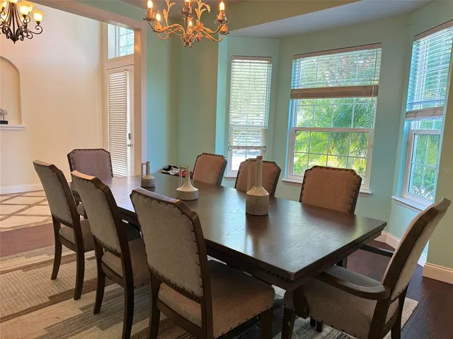 a view of a dining room with furniture and window