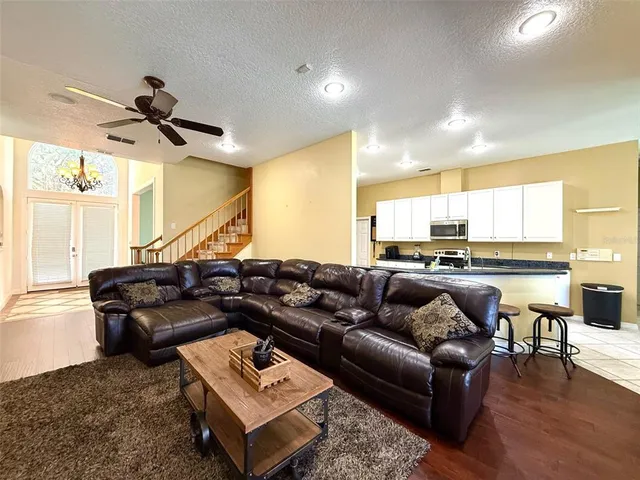 a living room with furniture and kitchen view