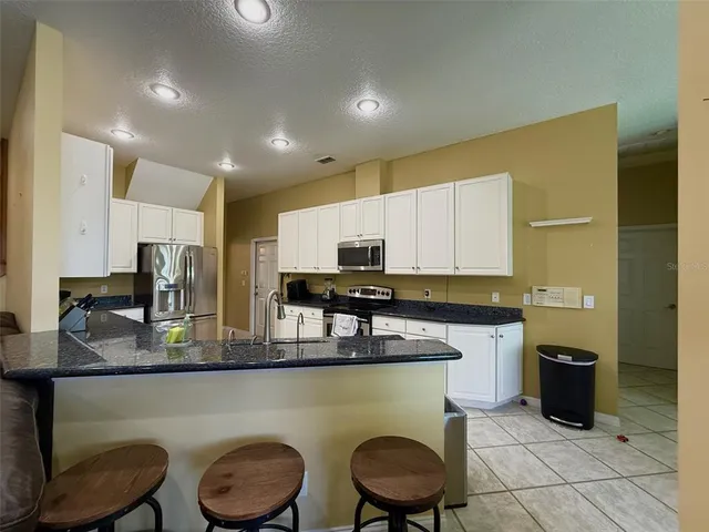 a kitchen with a sink cabinets and appliances