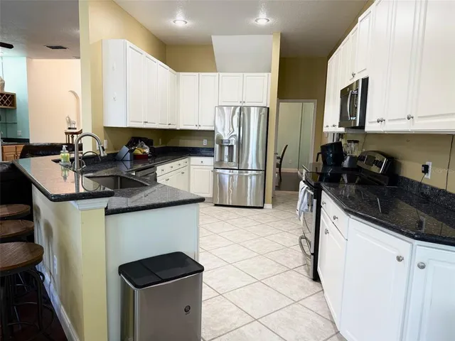 a kitchen with a sink stove and refrigerator