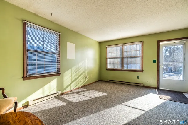 a view of a room with a window and brick walls