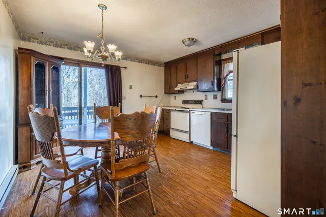 a kitchen with a refrigerator sink and cabinets