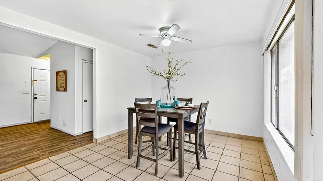 a view of a dining room with furniture and chandelier