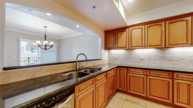 a kitchen with granite countertop sink cabinets and stainless steel appliances