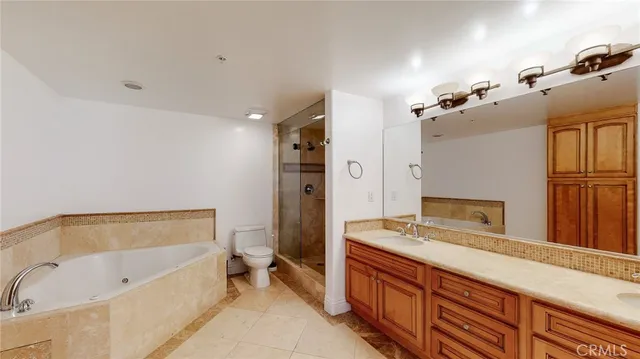 a bathroom with a tub sink and mirror