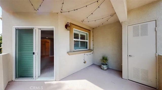 a view of a house with a potted plant and windows