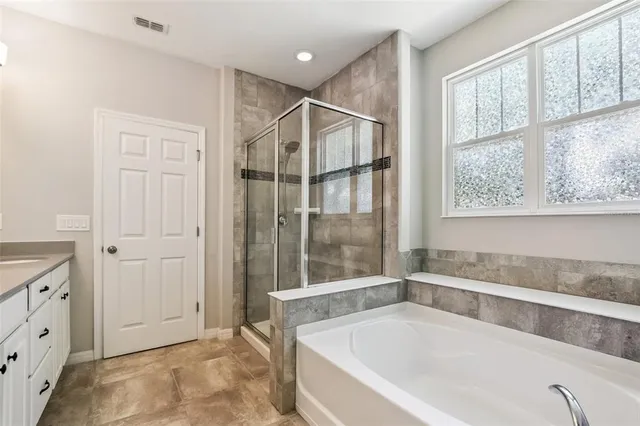 a bathroom with a bathtub and a shower