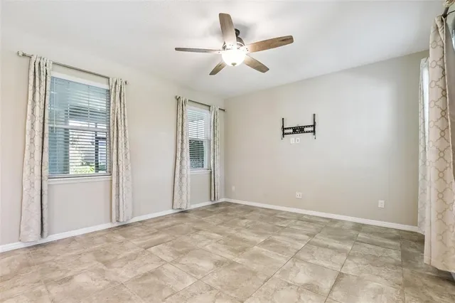a view of a livingroom with a ceiling fan and window