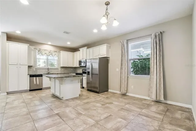 a kitchen with a refrigerator and a sink