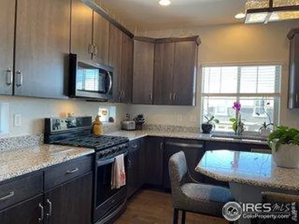 a kitchen with a stove a sink and a microwave