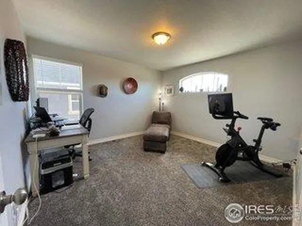 a view of a workspace with furniture and windows