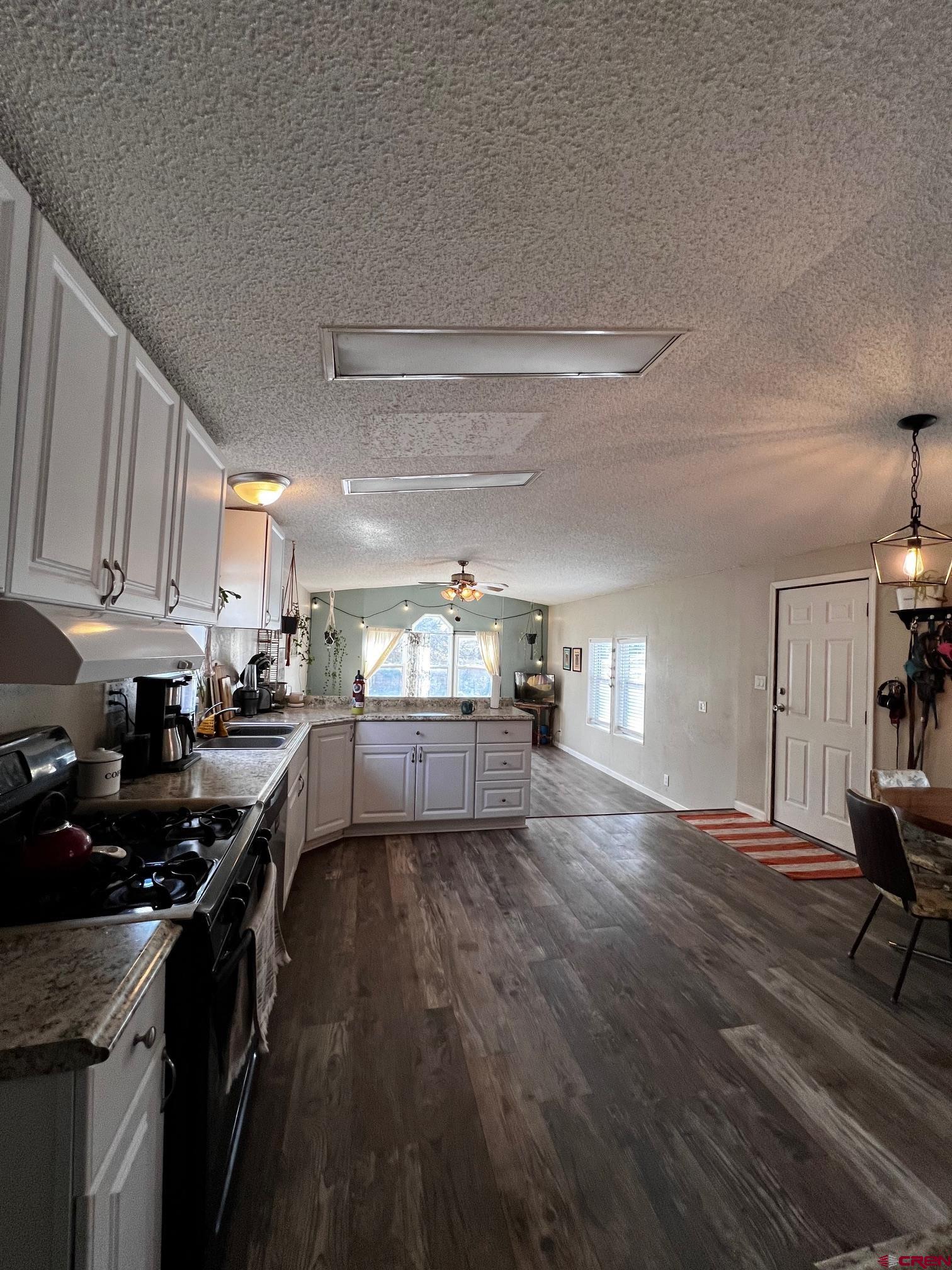 288 Animas View Drive, Unit 39 Durango, CO 81301 - Photo 14 of 14 a kitchen with stainless steel appliances a stove a sink a refrigerator white cabinets and wooden floor