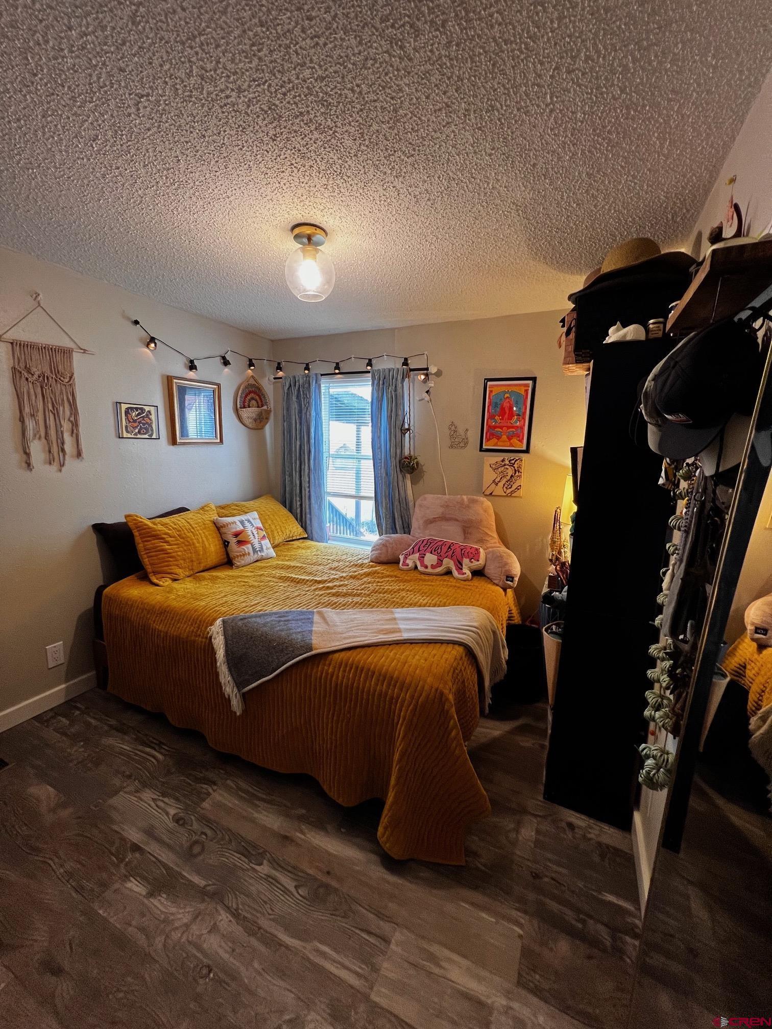 288 Animas View Drive, Unit 39 Durango, CO 81301 - Photo 6 of 14 a bedroom with a large bed and a walk in closet