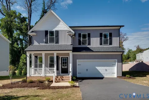 a front view of a house with a yard garage and outdoor seating