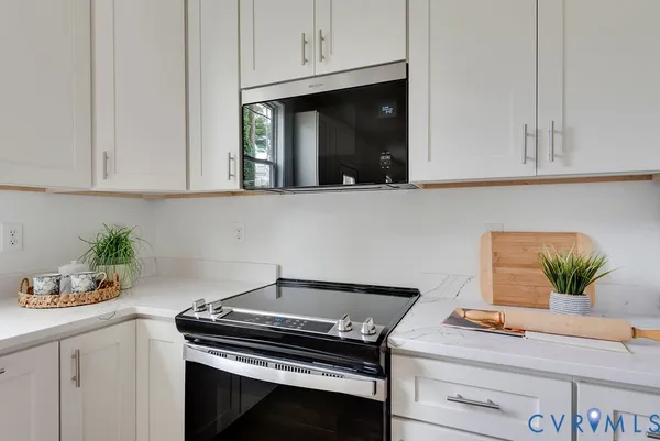 a kitchen with a stove and cabinets