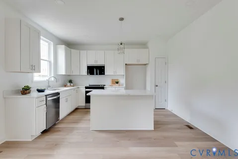 a kitchen with white cabinets and white appliances
