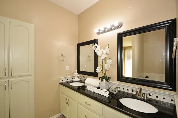a bathroom with a double vanity sink and a mirror
