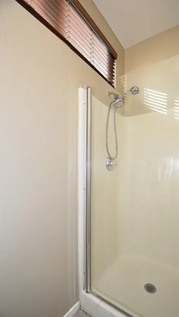 a bathroom with a glass shower door