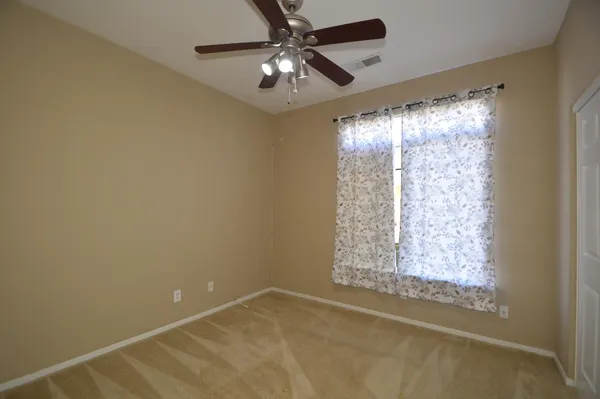 a view of room with window and ceiling fan