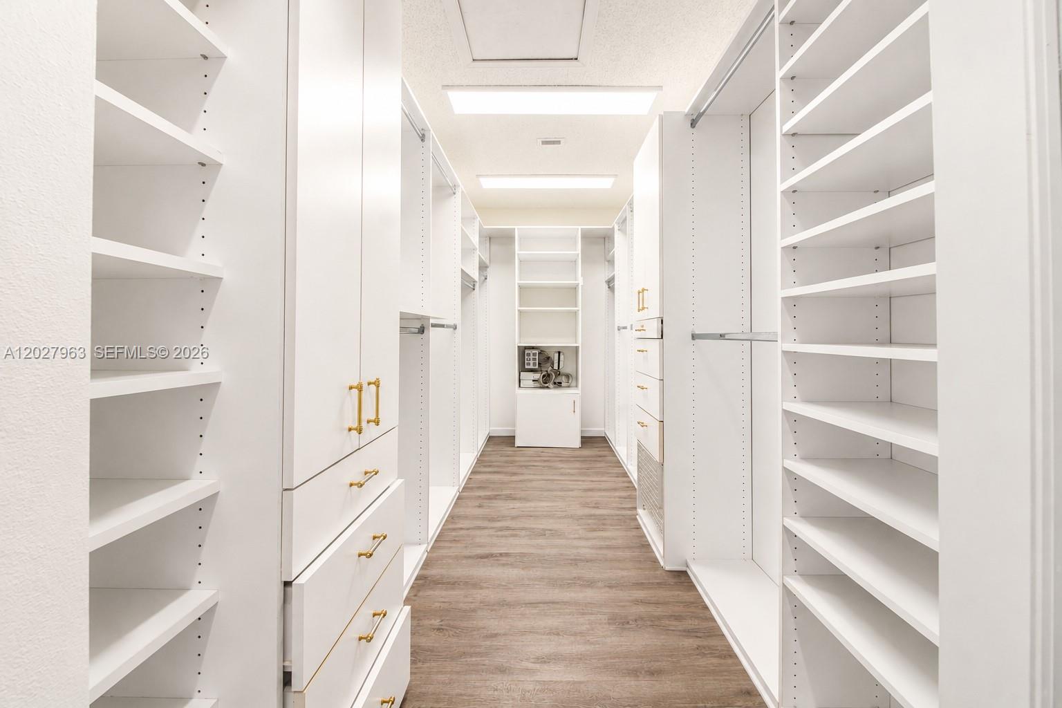 6646 Northwest 25th Terrace Boca Raton, FL 33496 - Photo 19 of 48 a view of a hallway with wooden floor and closet