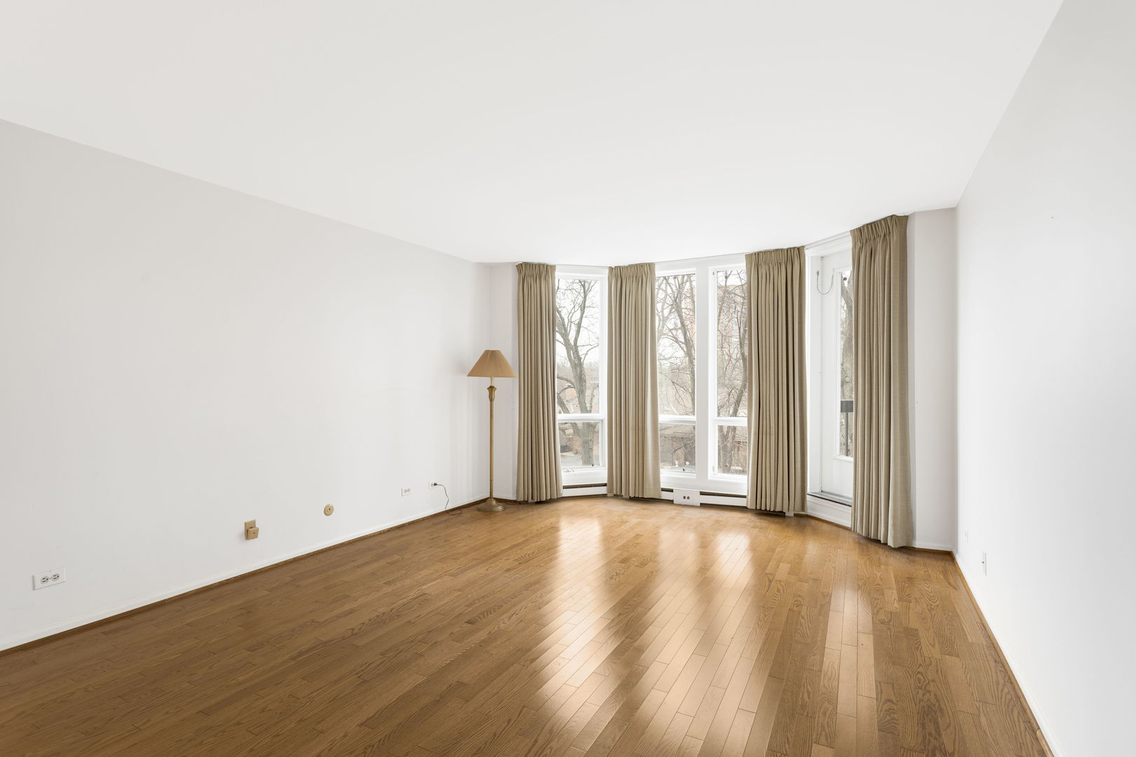 1140 Old Mill Road, Unit 304F Hinsdale, IL 60521 - Photo 11 of 21 an empty room with wooden floor and windows