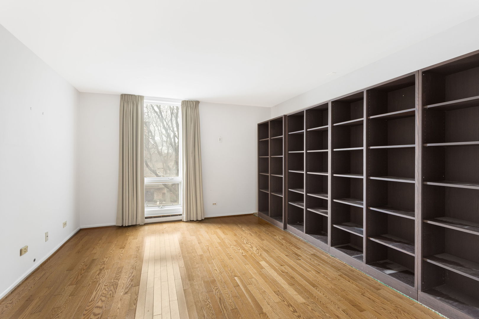 1140 Old Mill Road, Unit 304F Hinsdale, IL 60521 - Photo 13 of 21 a view of empty room with wooden floor and windows