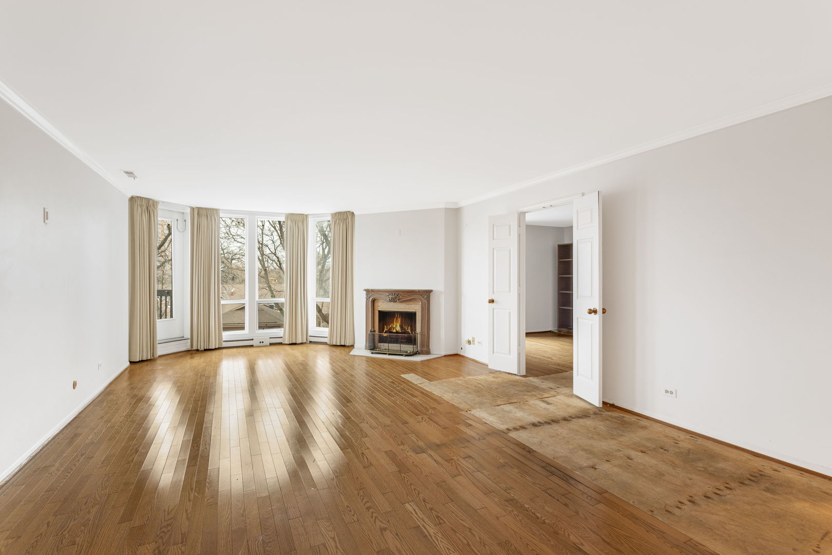 1140 Old Mill Road, Unit 304F Hinsdale, IL 60521 - Photo 6 of 21 a view of an empty room with a fireplace and a window