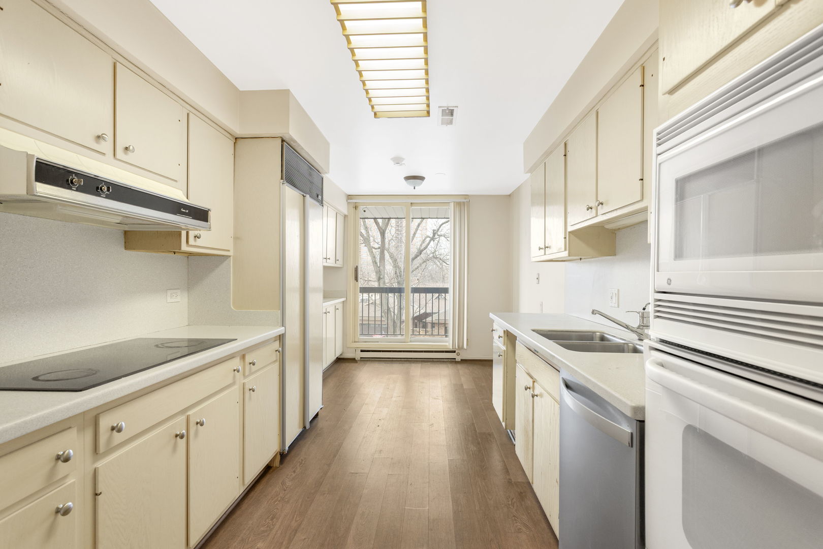 1140 Old Mill Road, Unit 304F Hinsdale, IL 60521 - Photo 8 of 21 a kitchen with stainless steel appliances a stove a sink and cabinets