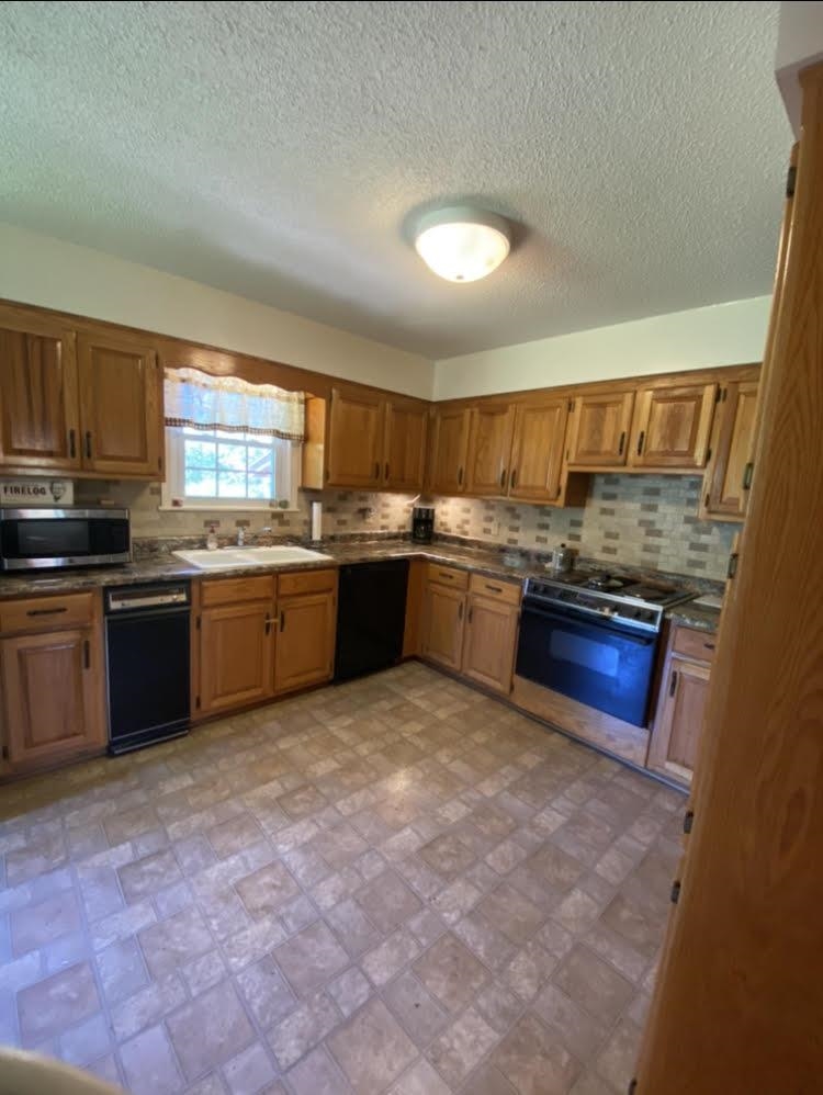 755 Old Toone Road Toone, TN 38381 - Photo 11 of 25 a kitchen with stainless steel appliances granite countertop a stove sink and cabinets