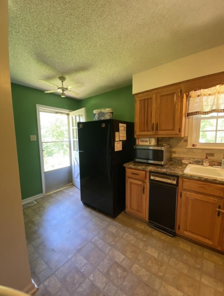 755 Old Toone Road Toone, TN 38381 - Photo 12 of 25 a kitchen with a refrigerator and a sink