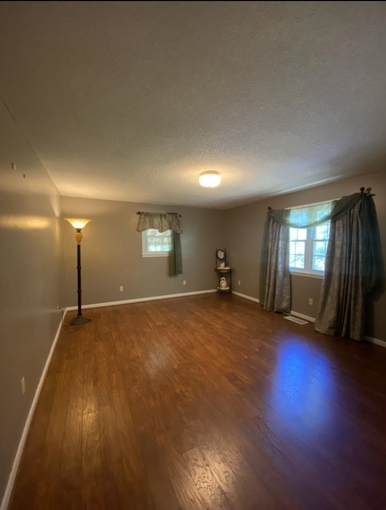 755 Old Toone Road Toone, TN 38381 - Photo 16 of 25 a view of empty room with wooden floor and fan