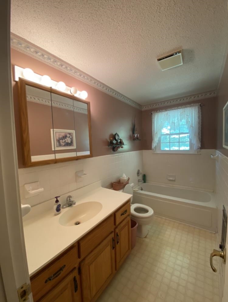 755 Old Toone Road Toone, TN 38381 - Photo 21 of 25 a bathroom with a bathtub a sink a mirror and a shower