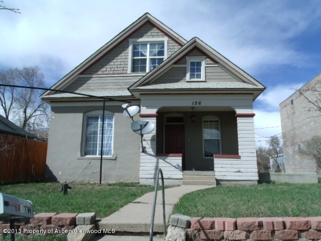 126 West 4th Street Rifle, CO 81650 - Photo 1 of 16 a front view of a house with a garden