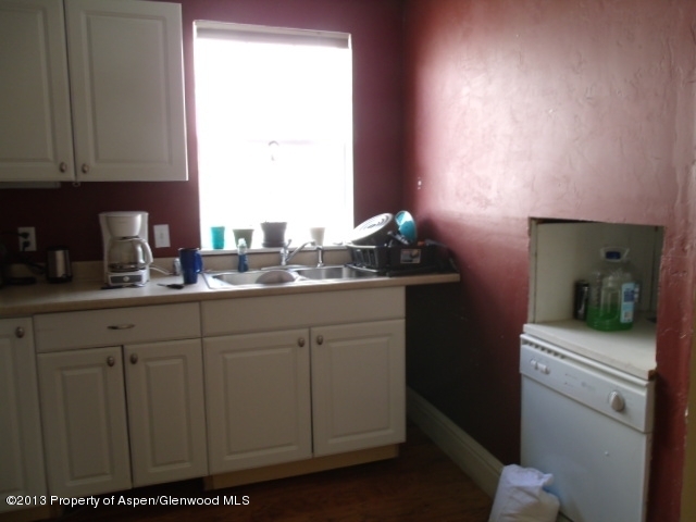 126 West 4th Street Rifle, CO 81650 - Photo 11 of 16 a kitchen with a sink cabinets and a window