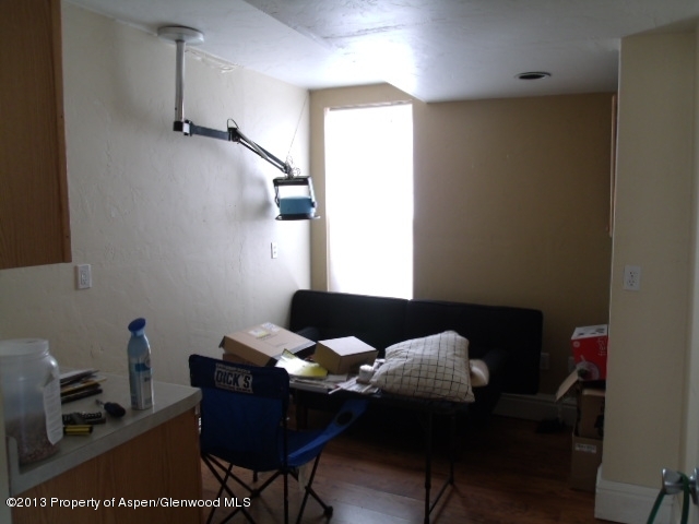 126 West 4th Street Rifle, CO 81650 - Photo 12 of 16 a living room with furniture and wooden floor