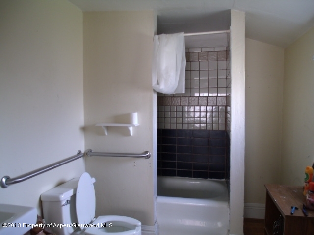 126 West 4th Street Rifle, CO 81650 - Photo 13 of 16 a bathroom with a shower and a toilet